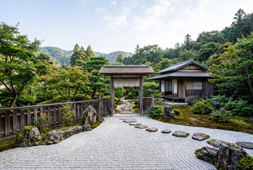 Fototapeta premium Traditional japanese zen garden with raked gravel and wooden gate