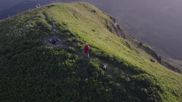 Man on top of a mountain peak at sunset in the Austrian Alps. Achenkirch, Austria