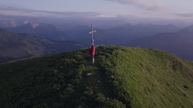 Man on top of a mountain peak at sunset in the Austrian Alps. Achenkirch, Austria