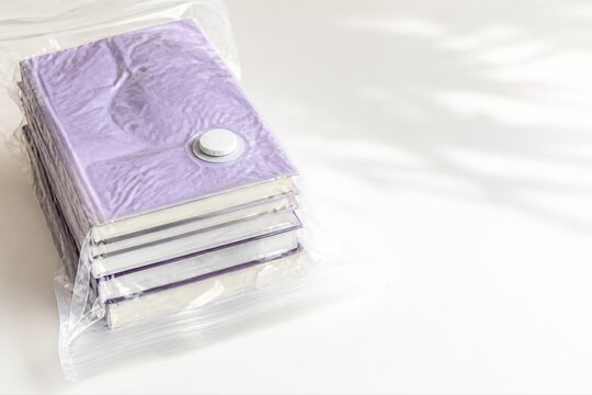 Vacuum sealed books in a plastic storage bag with copy space