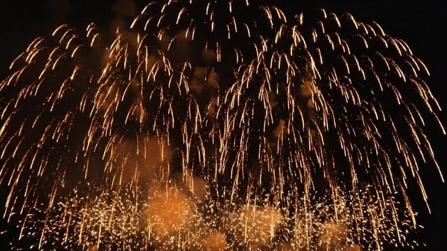 Golden fireworks exploding in the night sky during new year celebration