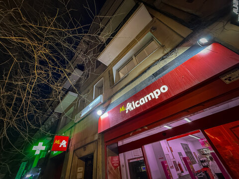 MADRID, SPAIN - FEBRUARY 23, 2026: Night view of an Alcampo supermarket entrance in Madrid, spain. Alcampo is the Spanish retail and hypermarket brand operated by the Auchan group.