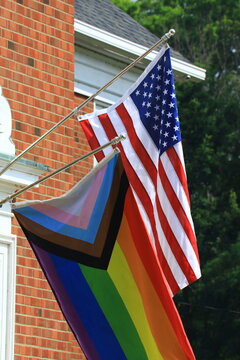 Rainbow flag displayed next to an American flag 