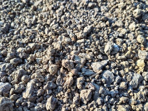 Natural dark gray asphalt and crushed stone surface texture