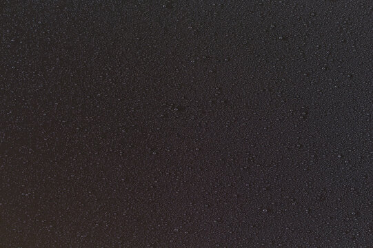 Fine water mist droplets on black background texture