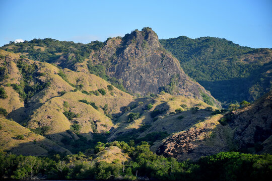 A beautiful landscape featuring cliffs and small hills around Padar and Rinca Islands, Labuan Bajo, Indonesia, on a clear morning.