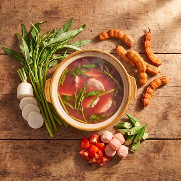 Ingredients laid out for preparing traditional Filipino sinigang soup recipe.