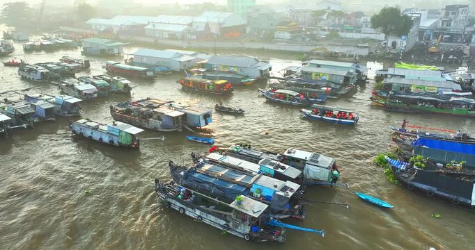 Bustling morning at Cai Rang Floating Market in Can Tho, Vietnam, where dozens of boats trade fresh fruits and agricultural products along the Mekong River