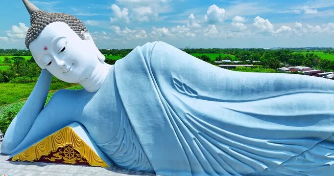 Majestic reclining Buddha statue at Som Rong Pagoda in Soc Trang, Vietnam, viewed from above on a bright sunny day. 