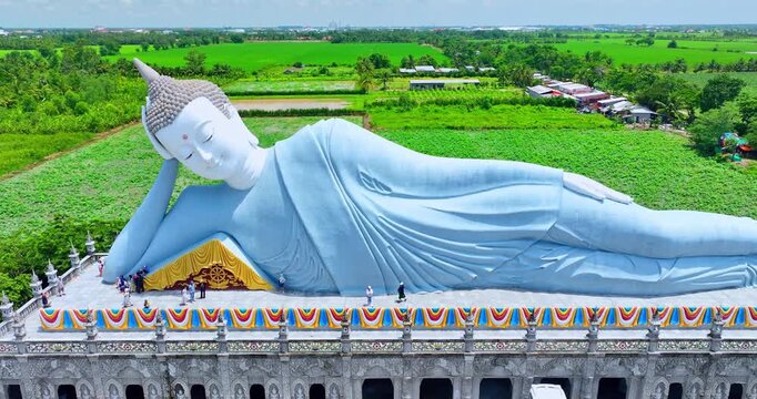 Majestic reclining Buddha statue at Som Rong Pagoda in Soc Trang, Vietnam, viewed from above on a bright sunny day. 