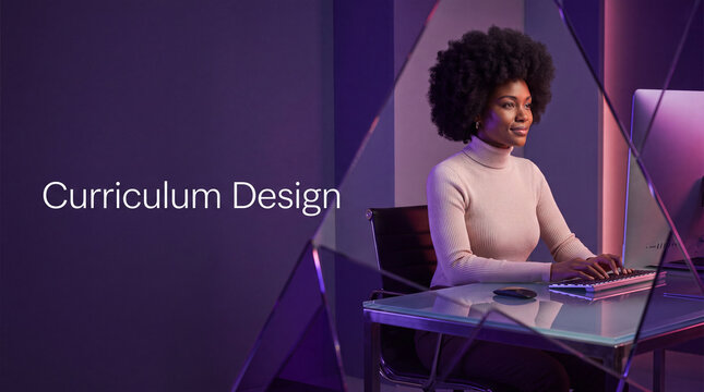 Black woman working on computer. Professional designer creating digital curriculum content.