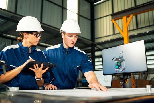 Teamwork in modern industry with detailed technical planning and collaboration.