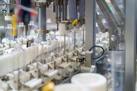 Automated Industrial Machine Processing Clear Plastic Bottles