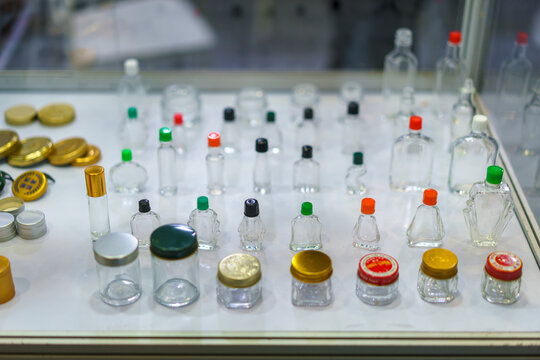Assorted Empty Glass Bottles and Cosmetic Jars on Display