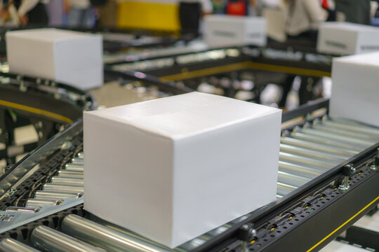 Blank White Box on Conveyor Belt in Warehouse