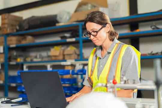 Logistics manager checking inventory on computer.