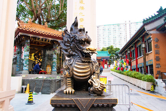 Hong Kong, January 21, 2026: Editorial image cultural and religious.	Bronze statue of Pixiu (Pi Yao) and Qilin, traditional Chinese mythical guardian prominently at entrance of Wong Tai Sin Temple. 