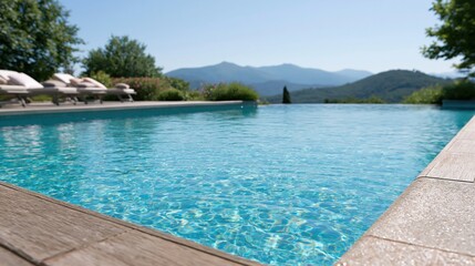 Fototapeta premium Luxury infinity swimming pool overlooking scenic mountain landscape on a clear sunny day