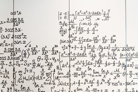 mathematical formulas, equations and geometric diagrams on chalkboard
