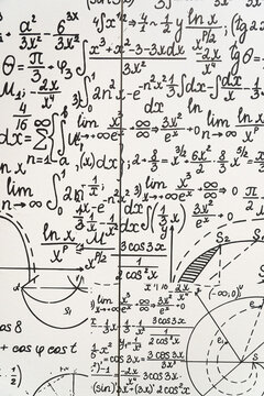 mathematical formulas, equations and geometric diagrams on chalkboard