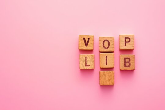 Wooden scrabble letters forming words on a vibrant pink background, showcasing a playful and creative arrangement perfect for word games or educational activities