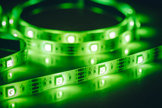 Green LED strip light close-up with glowing diodes
