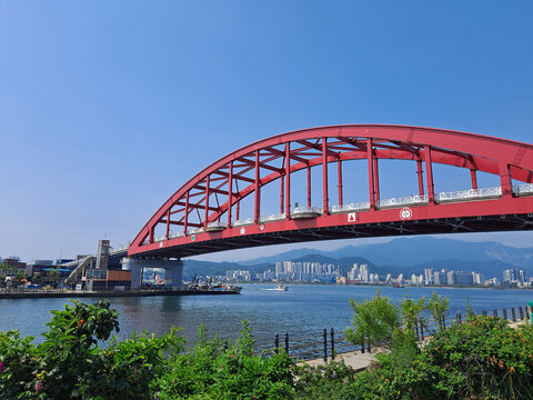 Red Arch Bridge Over Coastal Water