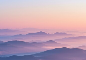 Obraz premium Soft pastel sunrise over layers of misty mountains, creating a serene and tranquil natural landscape