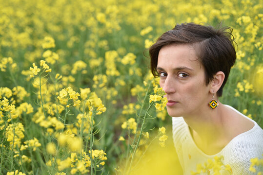 Brunette woman in a blooming field
