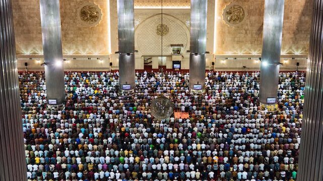 Asia, Indonesia, Jakarta, time lapse of Jakarta's Istiqlal mosque, with Muslims praying during Friday mass prayer. 