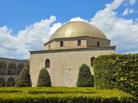 Golden dome of Ahmediye Mosque framed by green hedges at Rabati Castle in Akhaltsikhe, Georgia
