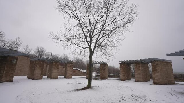 Ajax Water Supply Plant, historical commemorative site plaque next to bare tree in winter snow, Ontario, Canada, daytime, medium dolly shot.