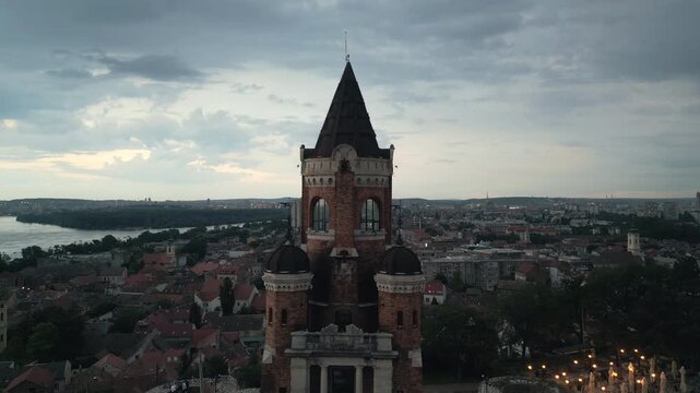 Slow rising drone shot revealing the Gardos Tower with panoramic view of Zemun at dusk, Belgrade, Serbia.