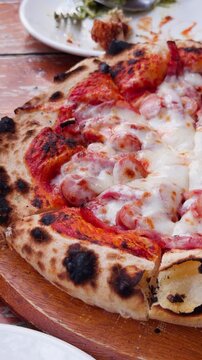 Artisan Wood Fired Pizza on Wooden Board Handheld Slow Pan Close-Up