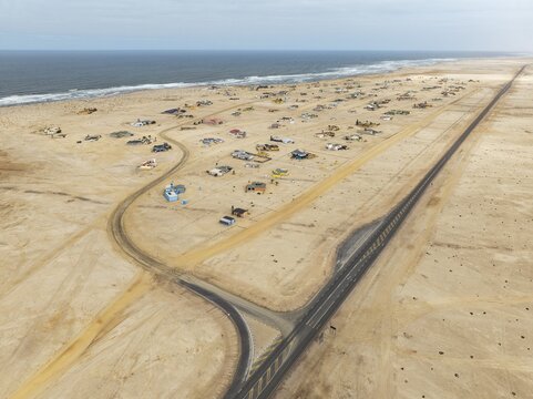 The odd holiday settlement of Wlotzkasbaken at the Atlantic coast. Aerial view. Drone shot. Namib Desert, Skeleton Coast, Namibia