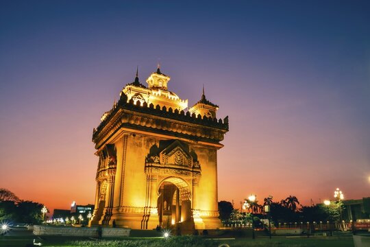 Vientiane, Laos - 15th february, 2025: Patuxai Victory Monument in Vientiane, Laos. The illuminated arch glows golden with purple blue hour sky at sunset