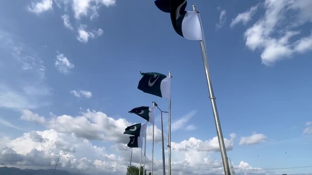 Pakistan country national flag waving on blue sky background.