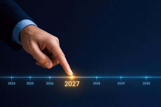 Business professional hand selecting 2027 on illuminated timeline bar representing strategic planning technology roadmap AI and future vision