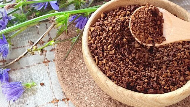 Ground chicory root, chicory flowers and chicory drink on a rustic wooden background. Alternative medicine. Healthy drinks