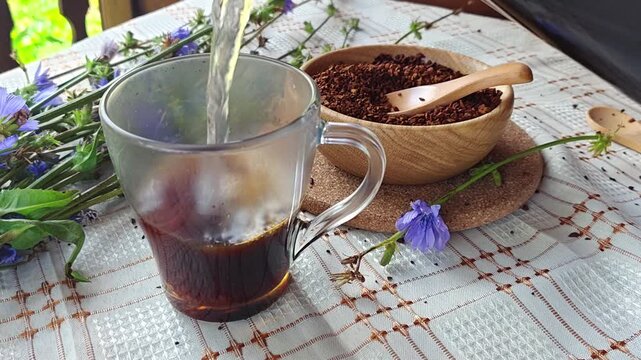 Ground chicory root, chicory flowers and chicory drink on a rustic wooden background. Alternative medicine. Healthy drinks