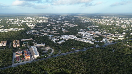 Obraz premium Aerial view of Tulum town expansion and residential neighborhoods surrounded by dense jungle, Mexico