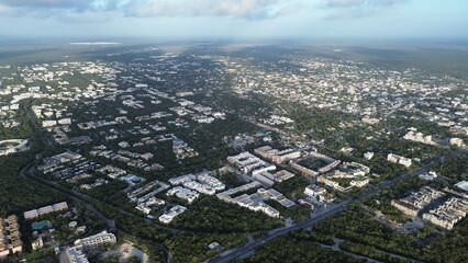 Fototapeta premium Aerial view of Tulum town expansion and residential neighborhoods surrounded by dense jungle, Mexico