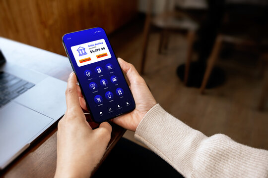 Person using a smartphone with a mobile banking application. Concept of digital payment, online finance, fintech, cashless transactions and banking.