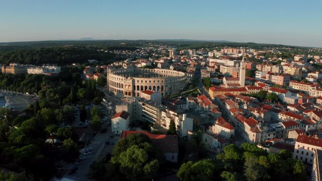 Drone view of Pula Arena as the drone flies up and the camera pans down