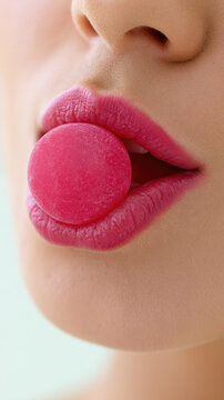 Close up lips touch pink gummy supplement, macro face detail in bright daylight with soft background and negative space