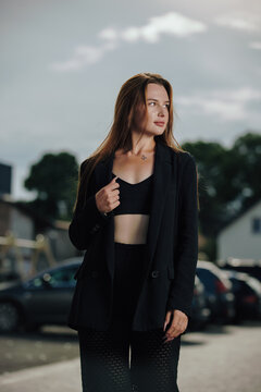 Portrait of beautiful brunette female model in stylish crop top and suit jacket
