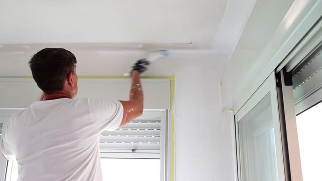 Professional painter renovating apartment with a brush