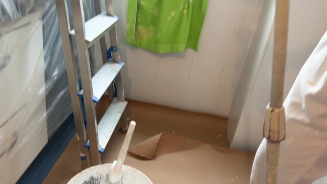 Professional painter applying white paint to a ceiling