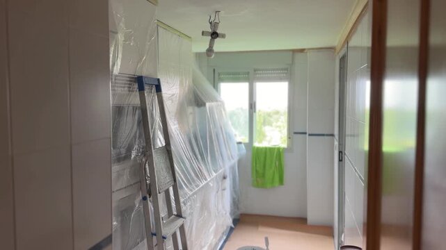 Kitchen renovation process with protective plastic covering furniture