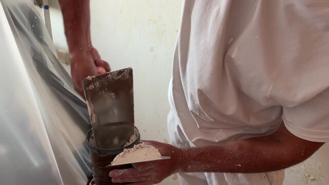Worker plastering a wall during renovation work